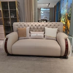 Cream Tufted Leather Sofa with Deep-Red High-Gloss Wood Side Panels